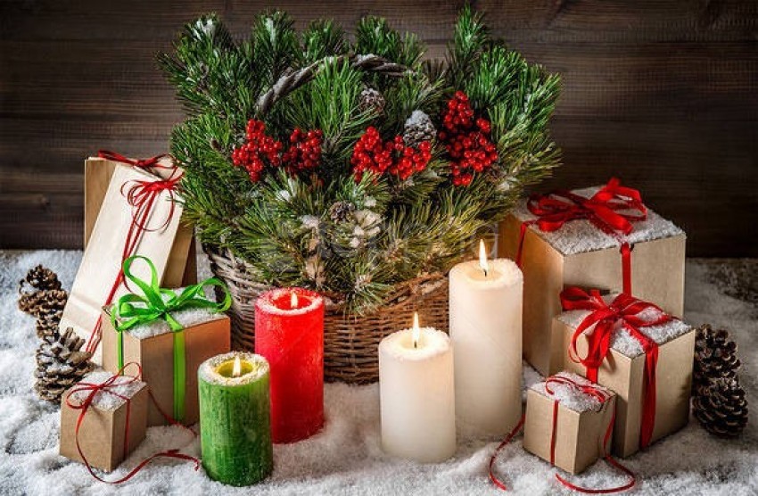 Christmas decor, holiday gifts, pine branches, red berries, festive candles, snow-covered decoration, wrapped presents