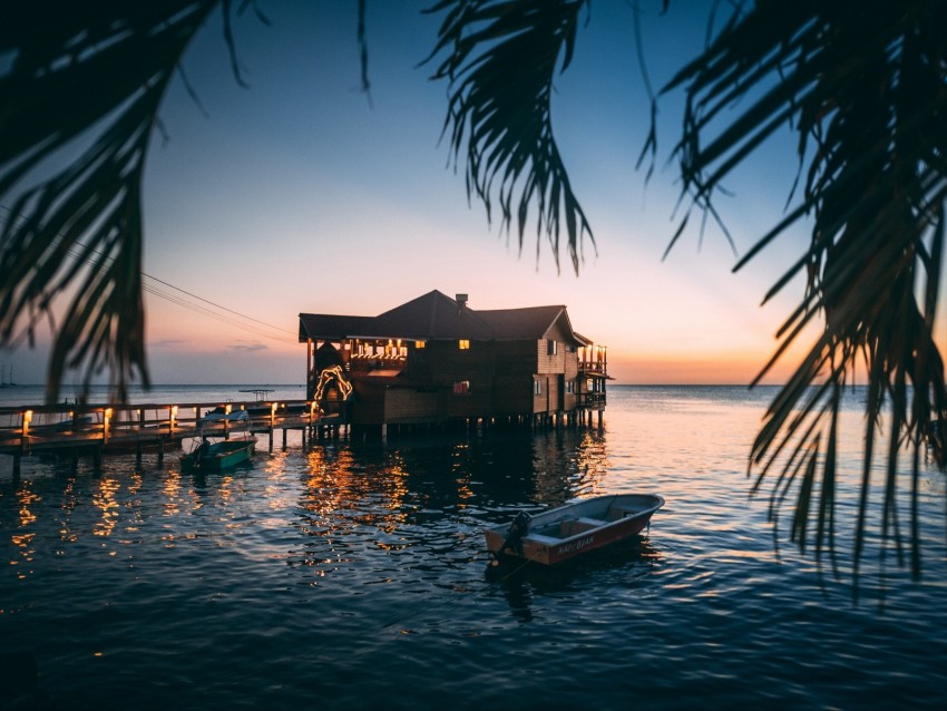 waterfront house, sunset scenery, tropical retreat, pier boats, serene landscape