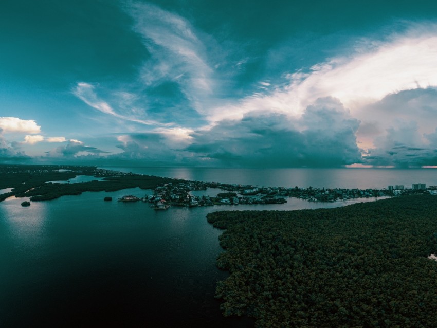 coastal landscape, aerial view, mangrove forest, tropical skies, serene waters