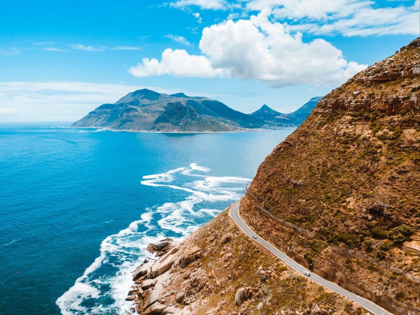 coastal landscape, ocean view, scenic drive, mountainous terrain, blue sky