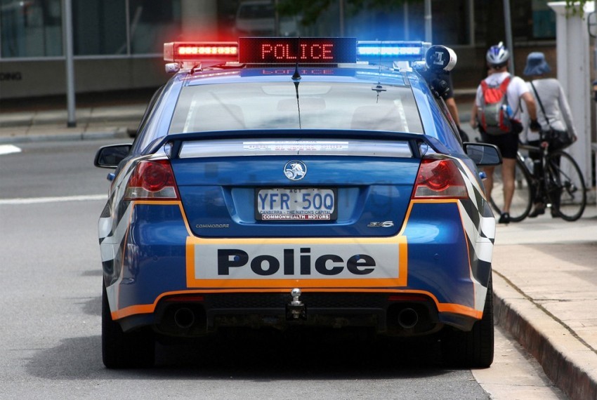 police car, blue vehicle, emergency lights, law enforcement, city street, traffic safety, police signage