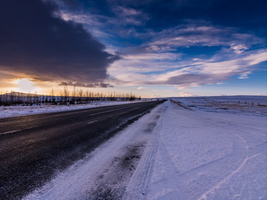 winter landscape, snowy road, dramatic skies, scenic view, sunset hues