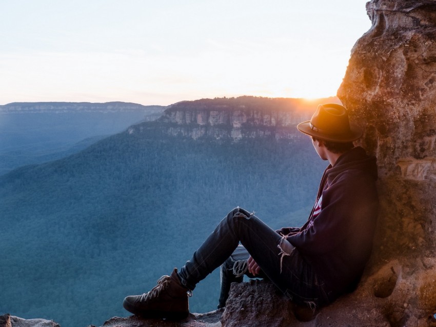 sunset view, mountain landscape, person sitting, outdoor adventure, nature photography