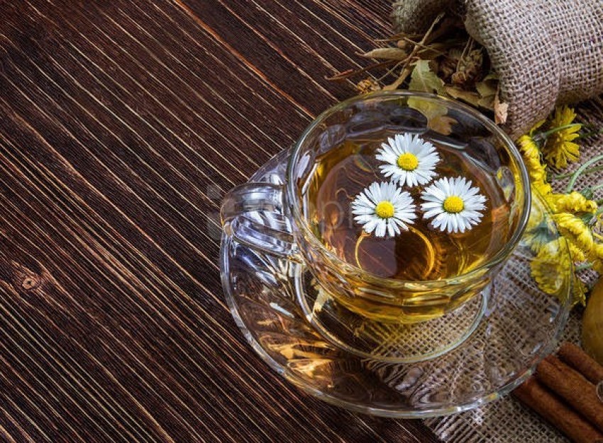 herbal tea, chamomile, flowers, natural beverage, glass cup, wooden surface, rustic decor